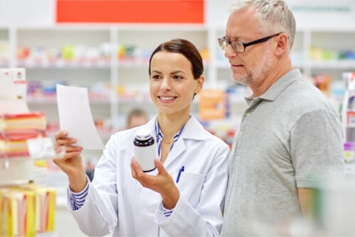 pharmacist and senior customer checking a prescription